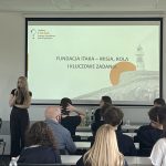 prelegentka na sali wykładowej prezentuje na ekranie